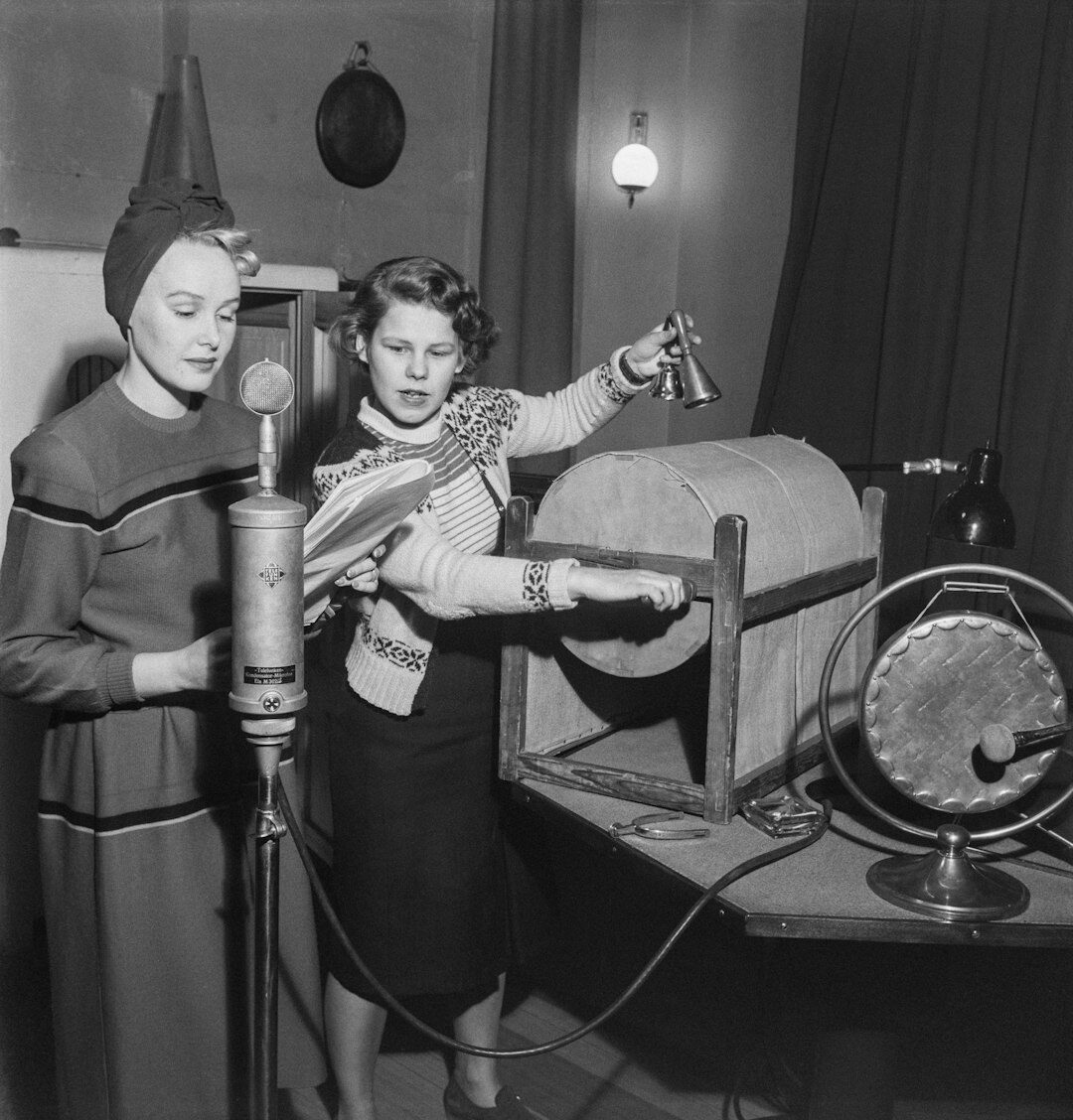 Female television reporter holding a microphone in a studio